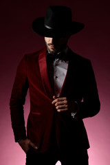 mysterious fashion man wearing red velvet tuxedo