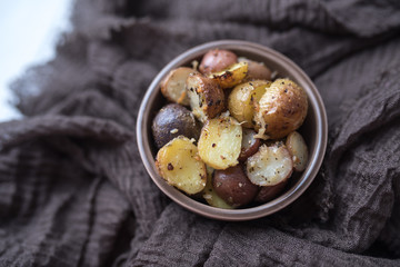Delicious Roasted mini potato with spices and Parmesan cheese, cut in halves