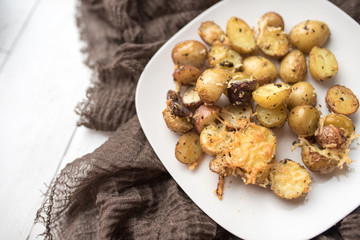 Delicious Roasted mini potato with spices and Parmesan cheese, cut in halves