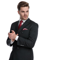 elegant businessman wearing double breasted suit and red tie