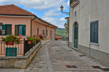 Fototapeta na wymiar Morra de Sanctis, Italy, 09/28/2019. The road between the houses of a quiet rural village, with typically Mediterranean architecture.