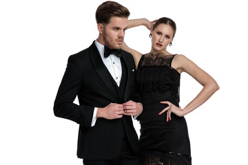 Young couple posing while she is leaning on him