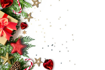 Christmas background, green pine branches, cones and gift box on white background. Creative composition with copy space, top view. New Year's holiday, christmas.