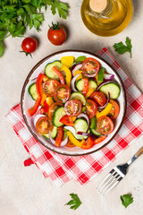 Vegetable salad on light table top view.