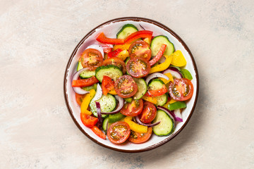 Vegetable salad on light table top view.