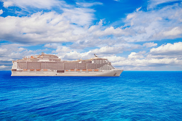 Luxury cruise ship vacation in blue azure sea sky with clouds. Concept travel background