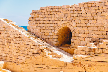 Ancient stone fort Malta island made of brick rocks on shore blue sea with view city Valetta