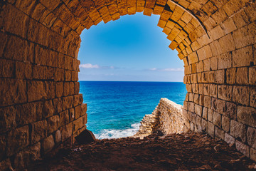 Ancient stone fort Malta island made of brick rocks on shore blue sea with view city Valetta