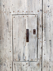 Old wooden rustic wall with small door.