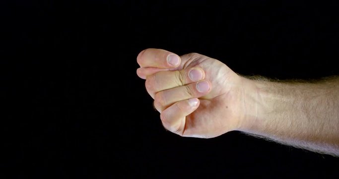muscular man hand shows fig and shakes thumb moving hand