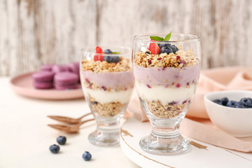 Dessert with blueberry and oat flakes in glasses on white table