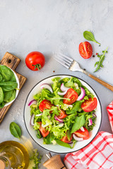 Green salad from fresh leaves and tomatoes.
