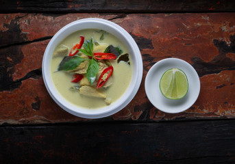 Top view Thai food chicken green curry isolated on rustic wooden table