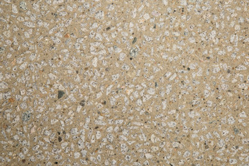 Texture béton désactivé en gros plan avec graviers blanc clair et gris foncé et couleur