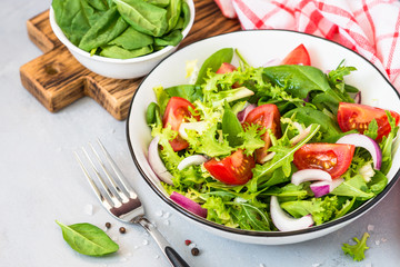 Green salad from fresh leaves and tomatoes.