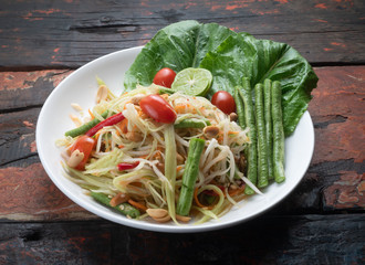 Top view Thai food rice noodle papaya salad isolated on rustic wooden table