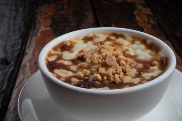 Traditional tukish rice pudding with walnut isolated on rustic wooden table