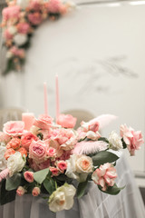 Decor for the holiday table. Natural flowers candle holders in pink colors.
