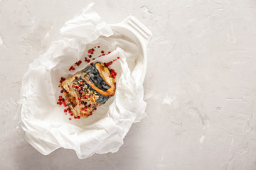 Dish with tasty roasted mackerel fish on light background