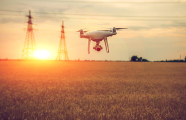 drone, quadrocopter in flight close-up at sunset.