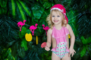 little happy girl in sunglasses and in a swimsuit