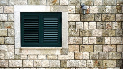 Window Shutters and Stone Facade.