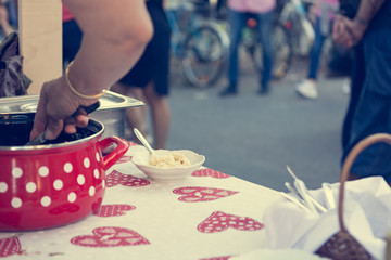 Close up of serving delicious pasta at outdoor event.