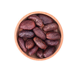 Peeled cocoa beans in the wooden bowl, isolated on white background. Roasted and aromatic cocoa beans, natural chocolate. Top view. Macro.