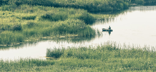 landscape with the lake and fisherman