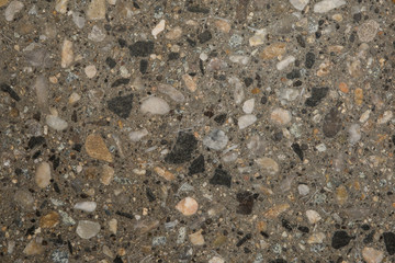 Gros plan texture béton désactivé avec graviers gris, noir et couleur