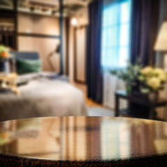 Wooden coffee table of free space for your decoration and blurred background of home interior. 