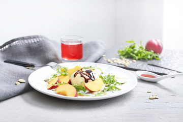 Plate with tasty salad on table