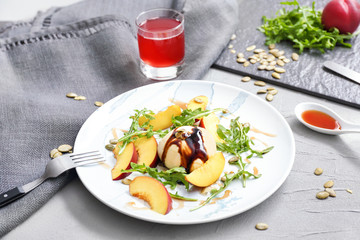 Plate with tasty salad on table