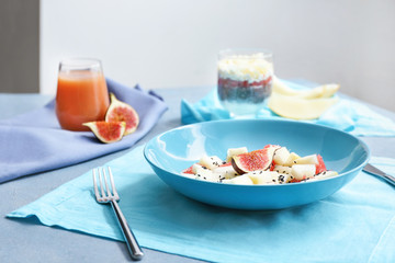 Plate with tasty salad on table