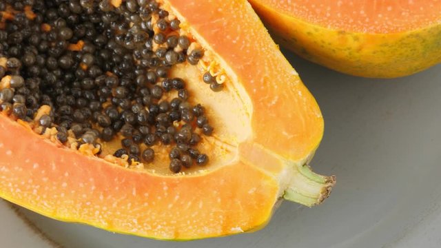 Top view of ripe half cut papaya, flat lay. Rotate