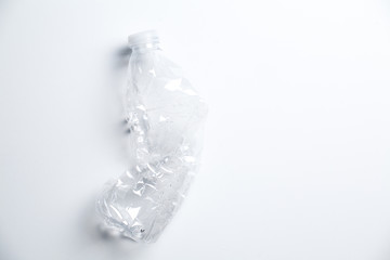 Smashed Plastic Water Bottle on White Background