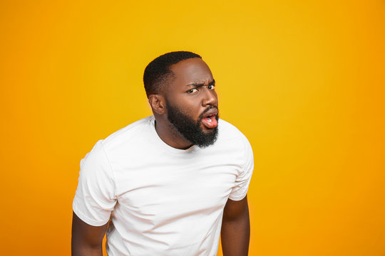 Shocked African-American man on color background