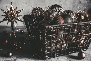 Wicker basket with Christmas toys and holiday decorations lights, copy space, new year decoration