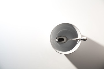 Empty White Cereal or Soup Bowl with a Silver Spoon on a White Background