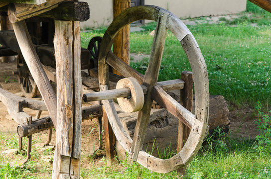 Old wooden carriage wheel in a barn     