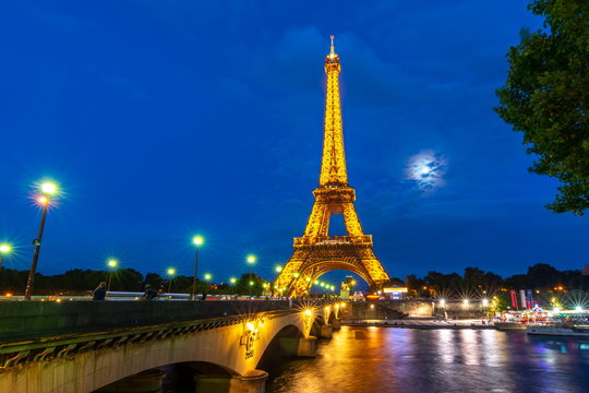 Eiffel tower and Seine river at night illumination, Paris, France