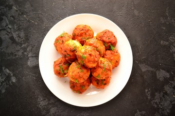 Meatballs in a white plate. Chicken meatballs with tomato sauce. Appetizing meat dish with gravy.