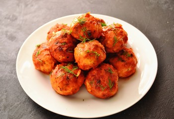 Meatballs in a white plate. Chicken meatballs with tomato sauce. Appetizing meat dish with gravy.