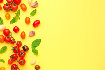 Fresh tomatoes with garlic and basil on color background