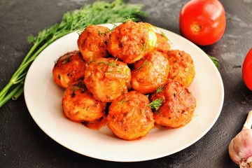 Meatballs in a white plate. Chicken meatballs with tomato sauce. Appetizing meat dish with gravy.