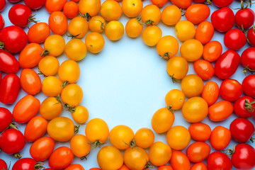 Frame made of fresh tomatoes on color background