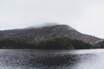 Norwegian landscape. Mountain in fog. Cloudy day.