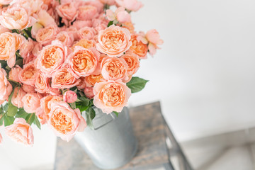 Roses of multicolor, pastel pink and pale orange color. Lots of buds. Floral natural backdrop. Flower shop concept