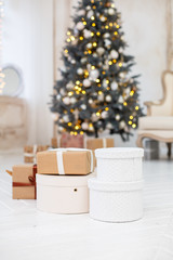 Christmas presents/gifts under fir-tree. Vintage New Year decorations. gift boxes and lantern under fir-tree. Christmas mood. Celebrating of New Year