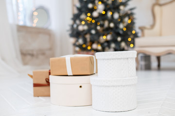 Christmas presents/gifts under fir-tree. Vintage New Year decorations. gift boxes and lantern under fir-tree. Christmas mood. Celebrating of New Year